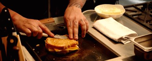 Jon Favreau in Chef making a grilled cheese sandwich
