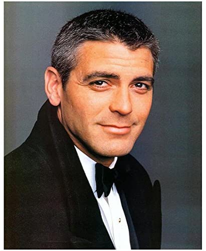 A young George Clooney smillng in a tuxedo