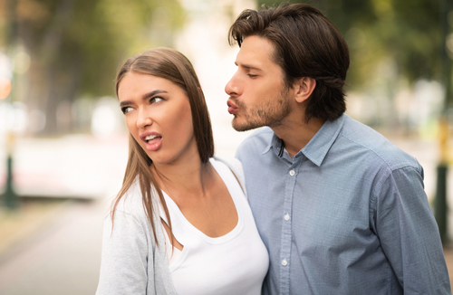 Disgusted Woman Rejecting a Kiss From A Man 
