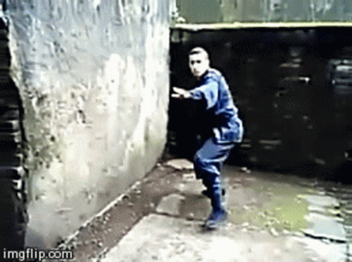 animated gif of East Asian man in a ninjitsu uniform in an alley throwing down a smoke bomb and disappearing