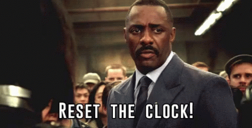 animated gif from Pacific Rim. Idris Elba in a suit in front of a crowd, addressing someone off screen. Text reads "Reset the clock!"
