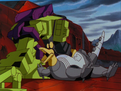 Still image from, Transformers: The Movie. Devastator pounds Sludge into the ground, his fist hammering Sludge's back. Sludge's eyes bug out like a Tex Avery cartoon