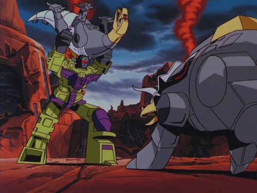 Screenshot from Transformers: The Movie. Devastator piledrives Sludge into Slag