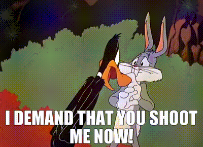 Animated clip from the Looney Toons short "Rabbit Seasoning". Daffy Duck yells at Bugs Bunny before turning to yell at Elmer Fudd. Text reads "SHOOT ME NOW. I DEMAND THAT YOU SHOOT ME NOW!"