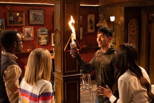 screenshot of The Good Place. Jason Mendoza is happily holding up a lit molotov cocktail and showing it to Eleanor, Tahani and Chidi